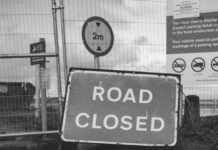 grayscale photo of road closed
