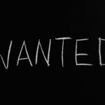 wanted lettering text on black background